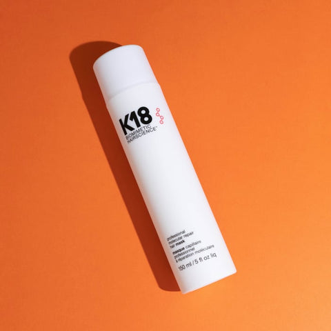 K18 Leave-In Molecular Repair Mask 150ml bottle on orange background